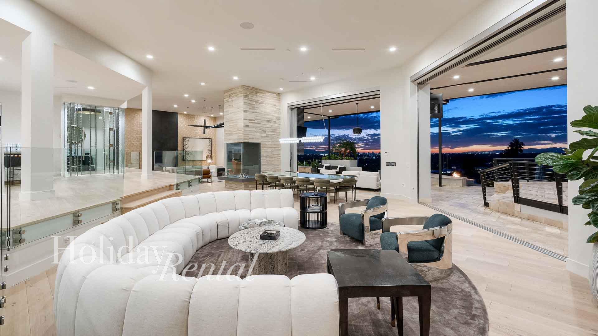 Indoor-outdoor great room opens seamlessly to the spacious patio and displays stunning views of the sunset