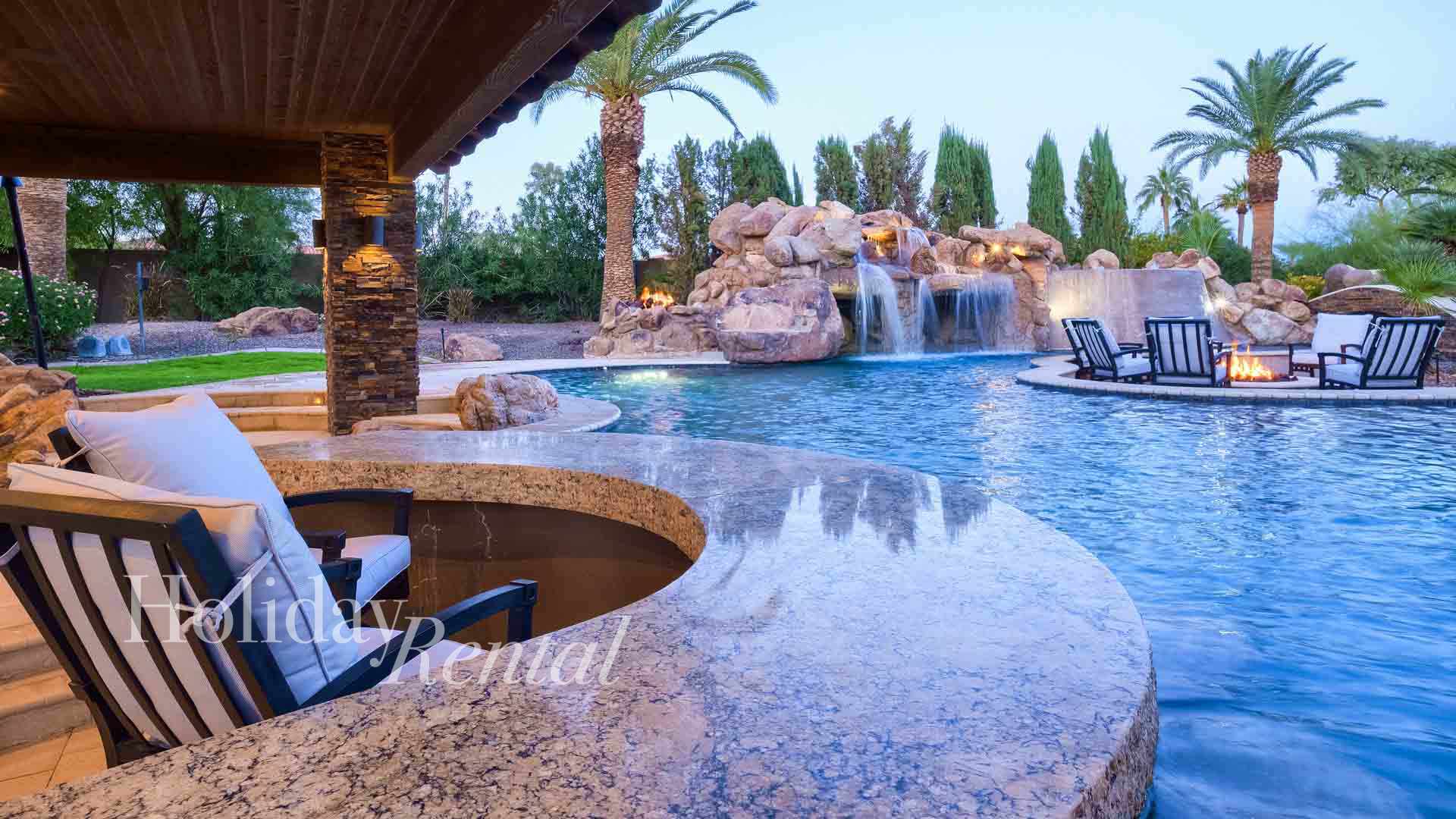 Sip on a drink at the swim up bar as you float along the lazy river, taking in the sights and sounds of the waterfall and fire pit in the distance